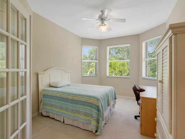bedroom with baseboards, light colored carpet, and ceiling fan