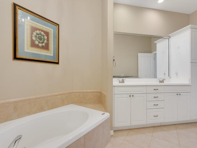 bathroom featuring double vanity, tile patterned flooring, a sink, and a bath