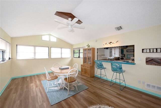 dining space featuring hardwood / wood-style floors, ceiling fan, plenty of natural light, and vaulted ceiling