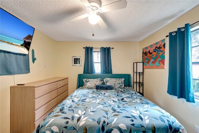 bedroom featuring a textured ceiling and ceiling fan