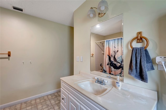 bathroom with vanity and a textured ceiling