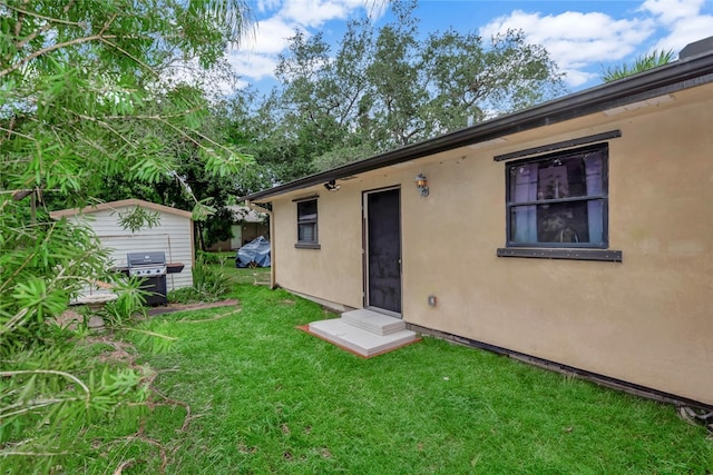 rear view of property with a yard