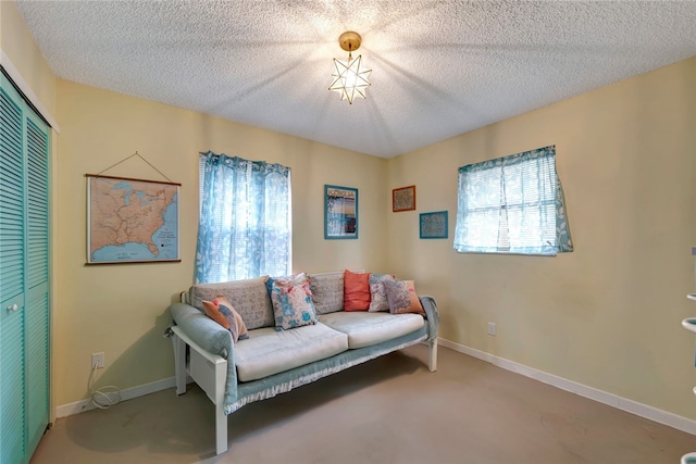 sitting room with a textured ceiling and carpet floors