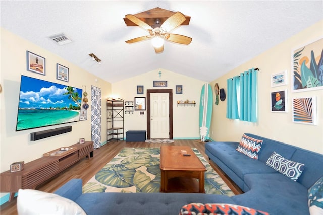 living room featuring lofted ceiling, a textured ceiling, hardwood / wood-style flooring, and ceiling fan