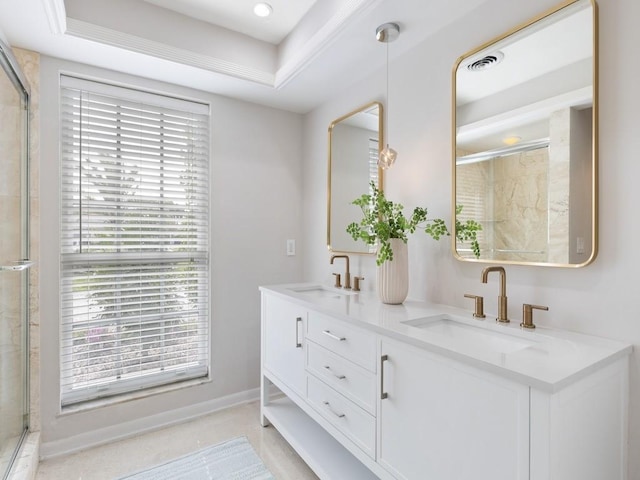 full bath with a healthy amount of sunlight, a shower with door, and a sink