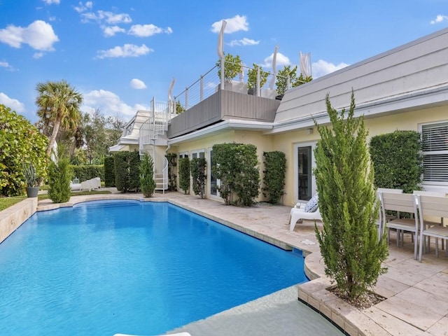 view of swimming pool featuring a fenced in pool, stairway, and a patio area