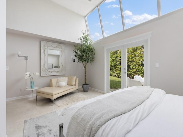 bedroom featuring carpet, baseboards, access to exterior, french doors, and a towering ceiling