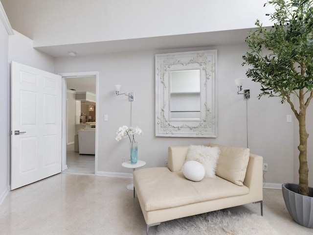 sitting room with speckled floor and baseboards