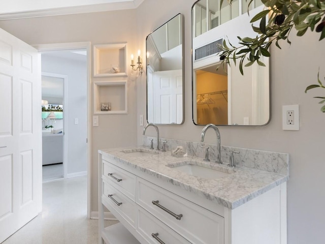 bathroom featuring built in shelves and vanity