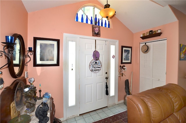 tiled foyer entrance featuring vaulted ceiling