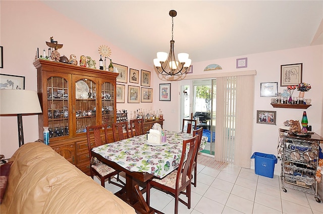 tiled dining space with a notable chandelier and vaulted ceiling