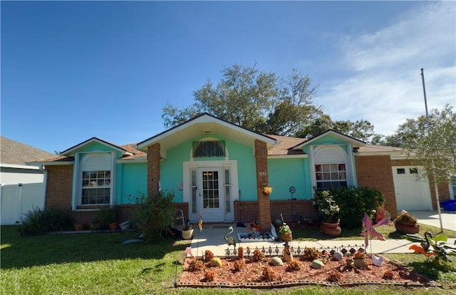 single story home with a garage and a front yard