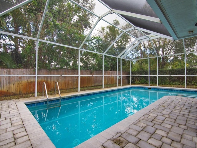 view of pool with a lanai and a patio area