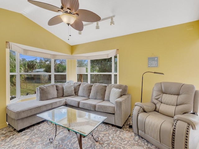 living room featuring rail lighting, lofted ceiling, and ceiling fan