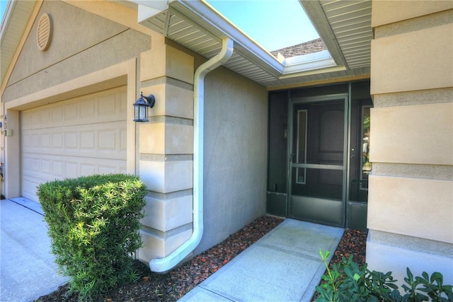 view of exterior entry featuring a garage