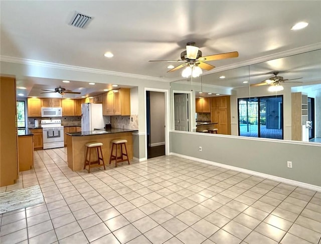 675 Colonial Dr, Vero Beach, FL 32962 - kitchen with white appliances, light tile patterned flooring, dark countertops, open floor plan, and crown molding