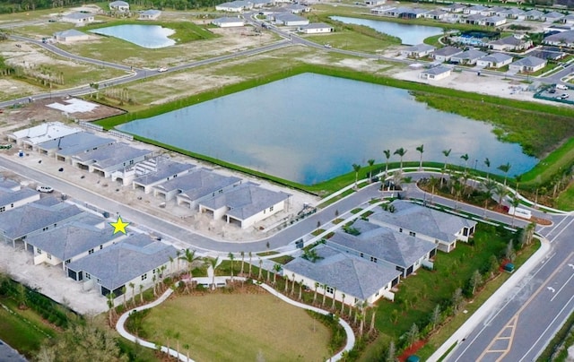 birds eye view of property with a residential view and a water view