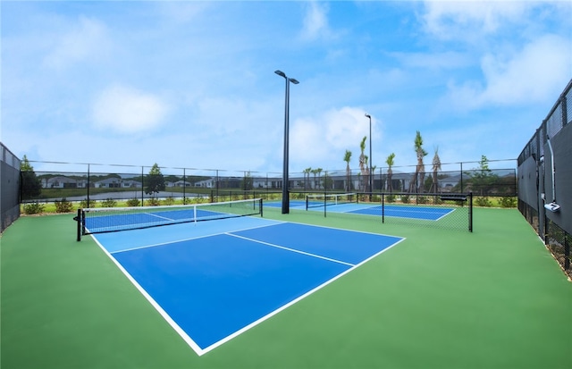view of tennis court with fence