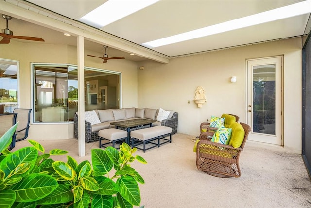 view of patio with an outdoor living space and a ceiling fan