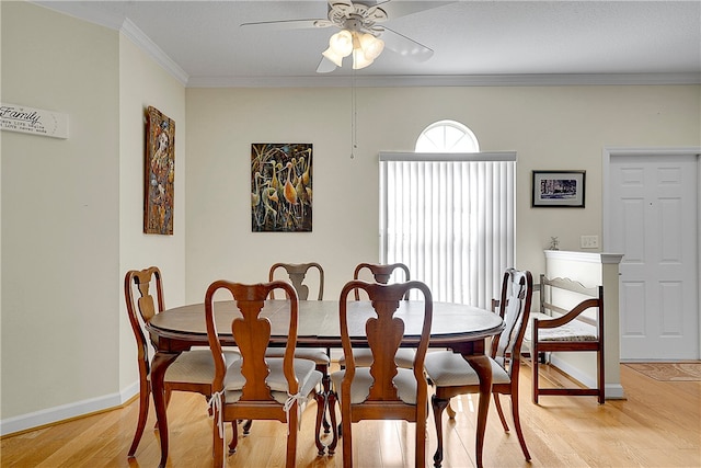 dining room featuring light wood-type flooring, ceiling fan, and ornamental molding