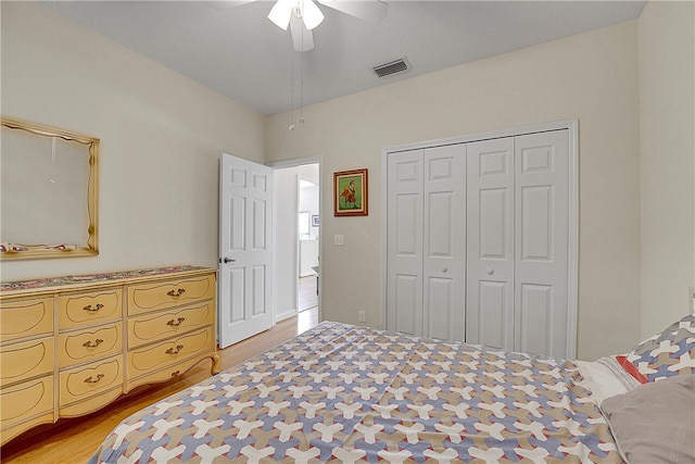 bedroom featuring ceiling fan, a closet, and light hardwood / wood-style flooring