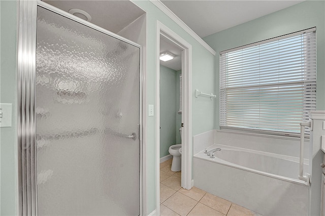 bathroom featuring toilet, tile patterned floors, and separate shower and tub