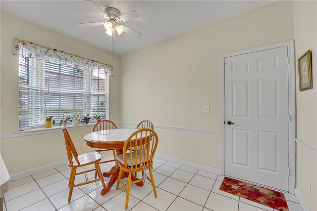 tiled dining area with ceiling fan