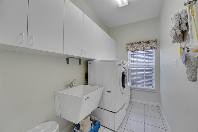 2540 46th Rd, Vero Beach, FL 32966 - laundry room featuring cabinet space, light tile patterned flooring, and baseboards