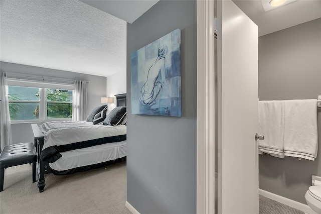 carpeted bedroom featuring a textured ceiling