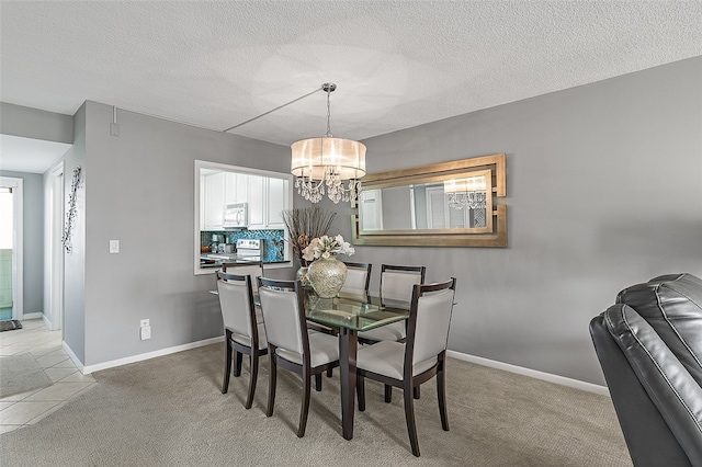 dining space featuring a notable chandelier, light colored carpet, and a textured ceiling