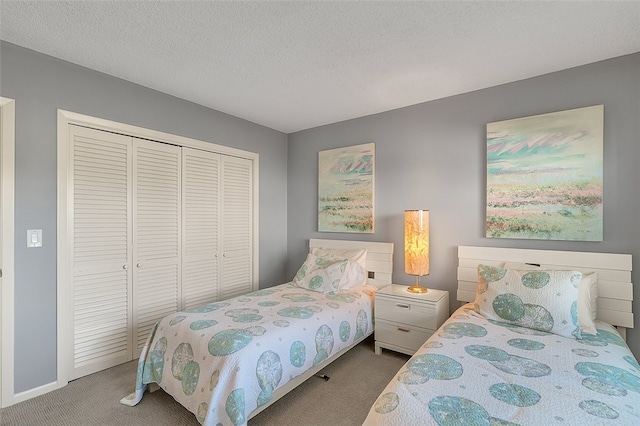 carpeted bedroom featuring a closet and a textured ceiling