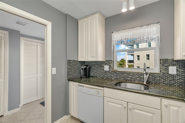 kitchen with white cabinetry, sink, backsplash, white dishwasher, and light tile patterned floors