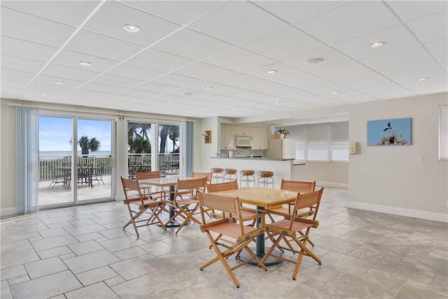 dining area with a drop ceiling