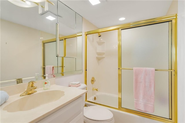 full bathroom featuring shower / bath combination with glass door, vanity, and toilet