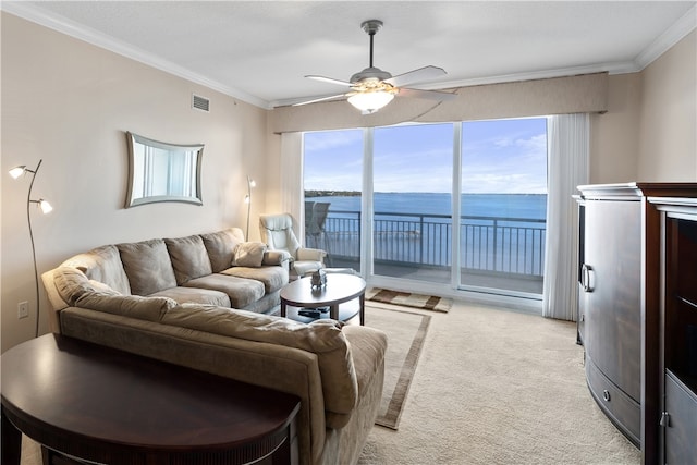 living room featuring light carpet, ornamental molding, ceiling fan, and a water view