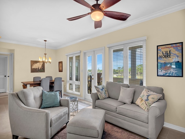 living room with tile patterned flooring, ceiling fan with notable chandelier, and ornamental molding