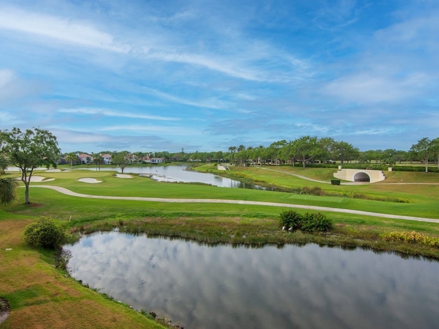 surrounding community with a yard and a water view