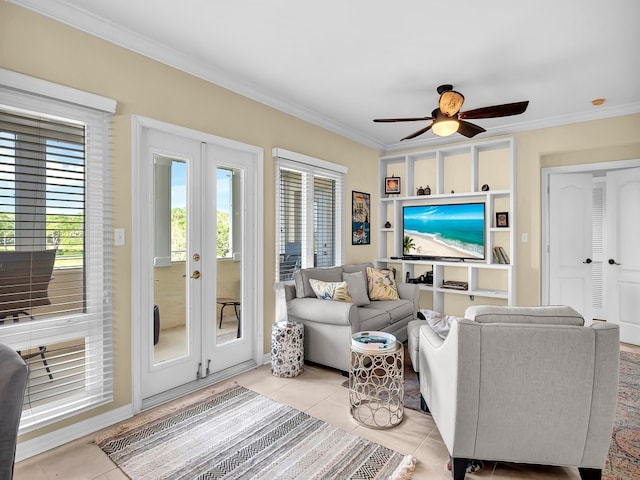 tiled living room with ceiling fan, crown molding, and french doors