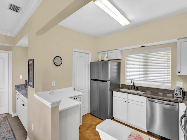 kitchen with crown molding, white cabinetry, sink, and stainless steel appliances