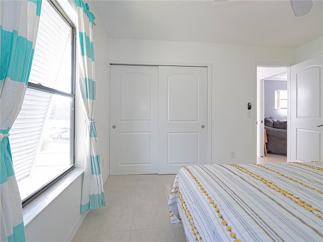 bedroom featuring a closet and light tile patterned floors