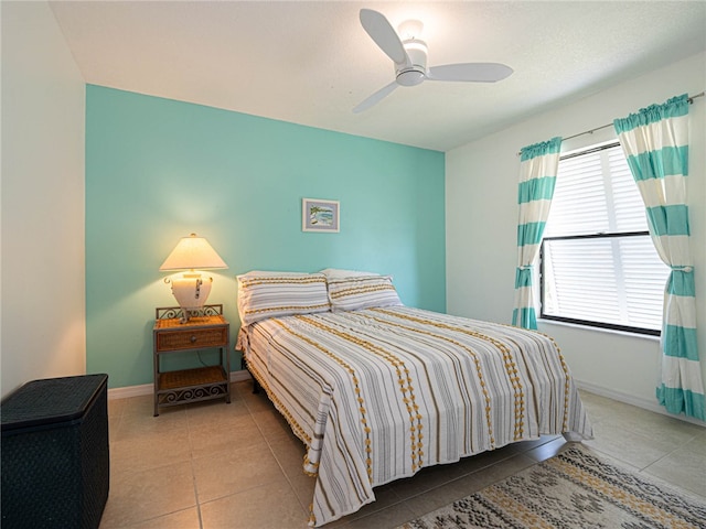 tiled bedroom with ceiling fan