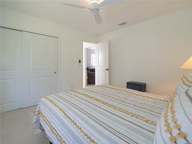 tiled bedroom with a closet and ceiling fan