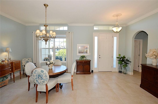 tiled dining area featuring ornamental molding and a notable chandelier