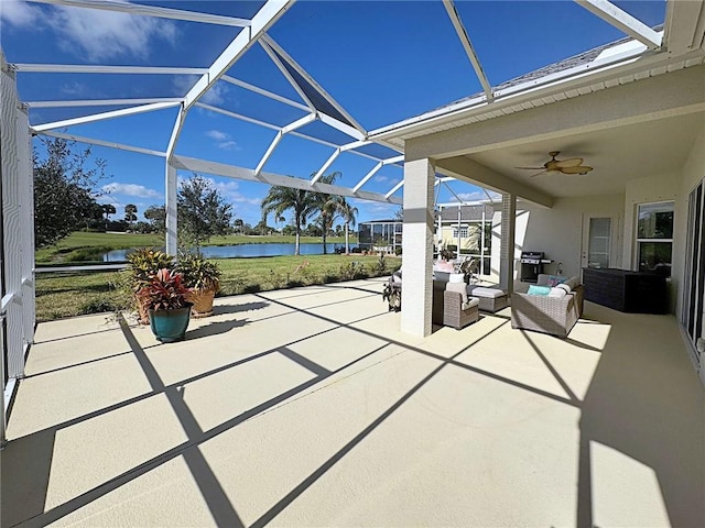 view of patio / terrace with a lanai, an outdoor living space, a water view, and ceiling fan