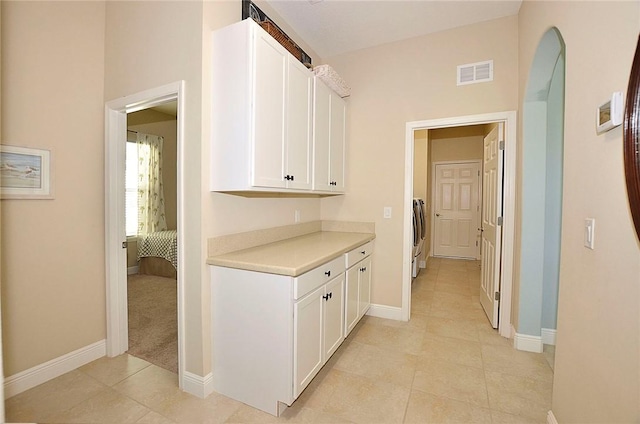 interior space with white cabinets, light carpet, and washer / clothes dryer