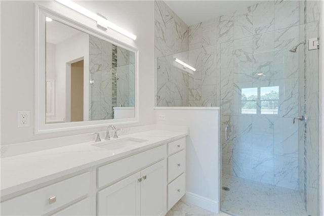 bathroom featuring marble finish floor, vanity, and a marble finish shower