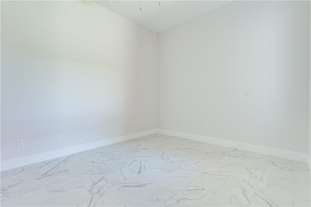 empty room with marble finish floor and baseboards