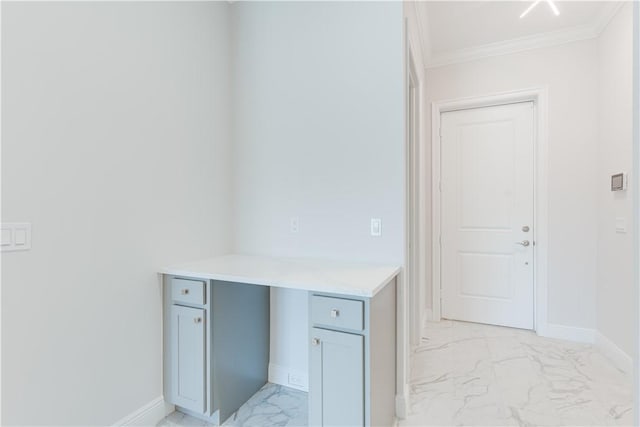 interior space featuring marble finish floor, baseboards, and ornamental molding