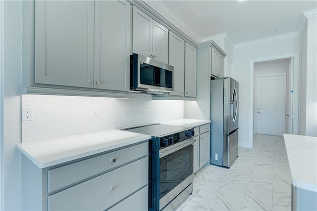 kitchen with appliances with stainless steel finishes, marble finish floor, light countertops, and gray cabinetry