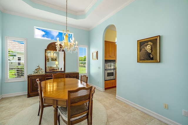 dining area with a raised ceiling, a notable chandelier, arched walkways, crown molding, and baseboards